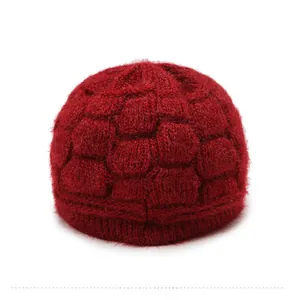 Detail view showing the honeycomb knit texture and thick ribbed edge of the burgundy winter hat