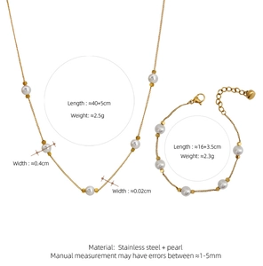 Detailed view of the gold titanium necklace and bracelet set with five white pearls