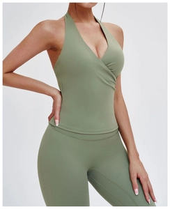 Detail of sage green V-neck halter yoga vest and high waist leggings on model