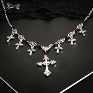 Vintage Gothic silver cross pendant necklace with dark red beads on black lace background