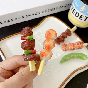 Funny realistic food hair clips featuring roasted meat skewers and shrimp balls