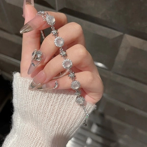 Detail of silver chalcedony flower bracelet with zircon circles and star charm links