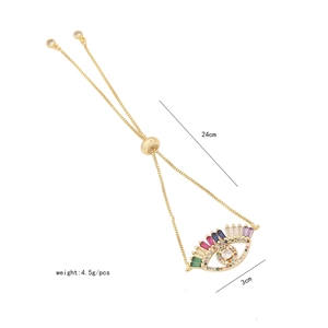 Detail of adjustable gold-tone evil eye bracelet with colorful cubic zirconia stones