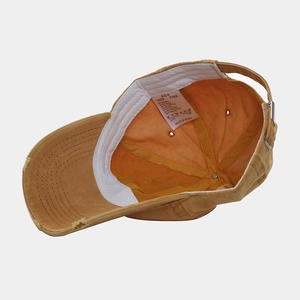 Washed yellow baseball cap with sun embroidery, showing inner details and vintage edge