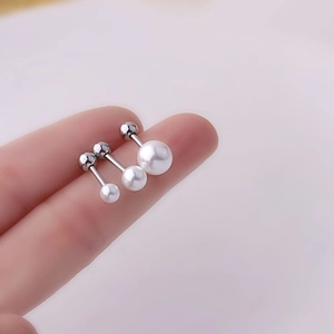 Detailed scale view of 1.2mm titanium pearl earrings with screw ball backs