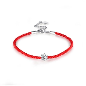 Macro detail of red woven rope bracelet with 925 sterling silver diamond-set clasp