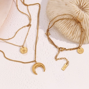 Detailed view of 18K gold plated stainless steel moon and star necklace and bracelet set