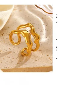 Close-up of golden irregular wavy ring with double-layered curved design on stone