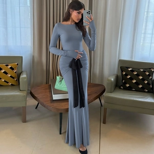 Detail of blue long sleeve slim dress featuring a contrasting black bow belt at the waist