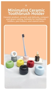 Close-up of minimalist colorful ceramic holders in ring shape for toothbrushes and pens