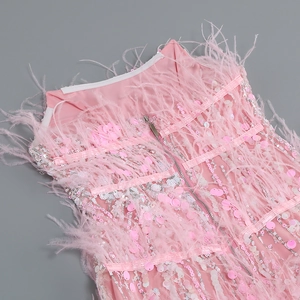 Detail of pink sequin dress featuring ostrich feather trim and a hidden back zipper closure