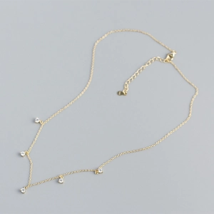Detailed view of S925 sterling silver gold necklace with five sparkling zircon pendants