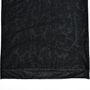 Detail of black fabric with silver glitter finish and stitched hem on evening dress