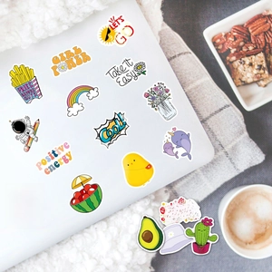 VSCO aesthetic PVC stickers with cartoon designs displayed on a laptop and desk