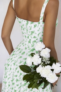 Detail of green floral backless maxi dress showing slim waist cut and woven fabric texture