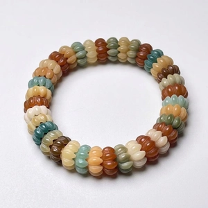 Multi-color cat claw beaded bracelet with natural stone texture on a white background