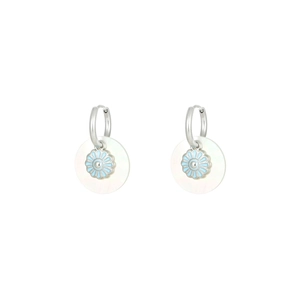 Close-up of titanium steel daisy flower earrings with white mother of pearl inlay