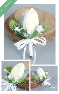 Detail of Style 1 white tulip boutonniere with silk ribbon and greenery for weddings