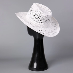 Detail of white hollow-woven straw cowboy hat featuring breathable texture and wide brim