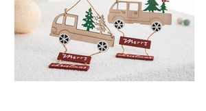 Detail of vintage wooden truck Christmas ornaments with miniature green trees on snow
