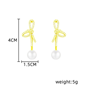 Detailed view of gold bow pearl earrings with dimensions 4cm x 1.5cm and 5g weight
