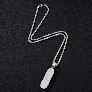 Close-up of silver iced-out scooter pendant with sparkling crystals on rope chain