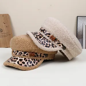 Close-up detail of retro leopard print flat top hat with decorative belt and M logo