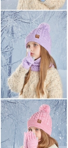 Detailed knit texture of pink and purple winter hat scarf and glove set for kids