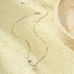 Polished silver stainless steel necklace with knot design and round bead pendant