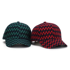 Detail of checkered baseball caps in green-black and red-black plaid patterns