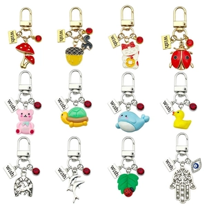 Set of 12 enamel dolphin and animal keychains with wish charms and red crystals