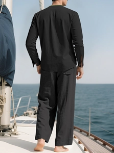 Men's black linen casual set with long sleeve shirt and trousers on a sailing boat
