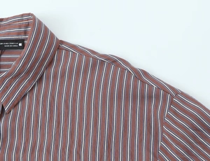 Detail of blue and white striped brown poplin shirt featuring XS size collar label