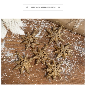 Set of 6 hollow gold electroplated 3D star ornaments for Christmas tree decor on wood