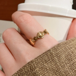 Macro view of 18k gold plated tiger eye stone ring worn in a cozy lifestyle scene