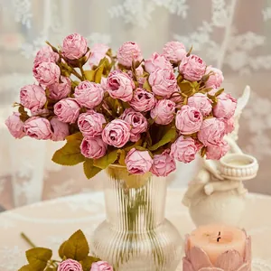 Realistic artificial pink rose bouquet in glass vase for home interior decoration