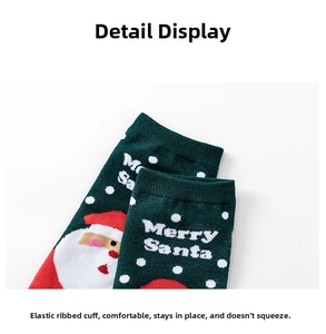 Close-up of elastic ribbed cuff and Merry Santa pattern on green Christmas cotton socks