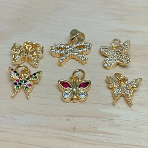 Macro view of crystal zircon butterfly and dragonfly pendants with gold plating for DIY jewelry