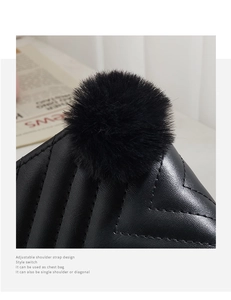 Close-up of black PU leather quilted pattern and decorative faux fur pom-pom detail