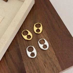 Minimalist 925 silver pig nose stud earrings in gold and silver finish on display