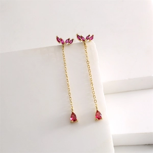 Detail of 18K gold-plated tassel earrings with marquise and teardrop red zircon stones