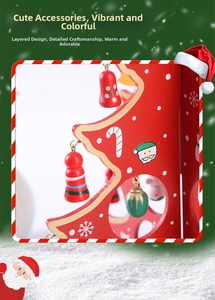 Detail of red wooden Christmas tree decor with small bells and painted Santa Claus figure
