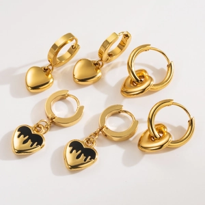 Three pairs of stainless steel gold heart earrings with solid, black drip, and hoop designs