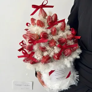 DIY Christmas strawberry bouquet tower with red bows and white feathers in a gift bucket