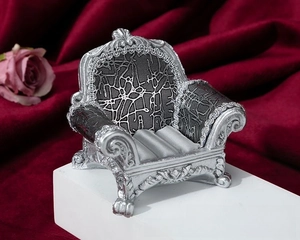Macro shot of silver vintage sofa-style jewelry stand with three slots for rings and earrings
