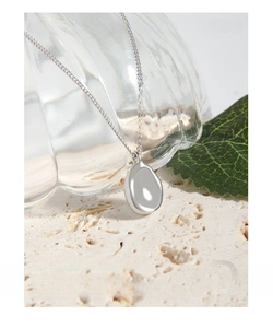 Close-up detail of a minimalist S925 sterling silver necklace with an oval pendant