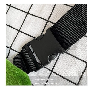 Detail view of durable black plastic buckle and nylon strap on green plush pea bag