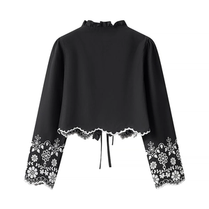 Back view of black cotton shirt with floral embroidery on sleeves and bow tie detail