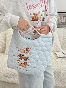 Quilted winter shoulder bag in light blue with cute dog embroidery and colorful handles