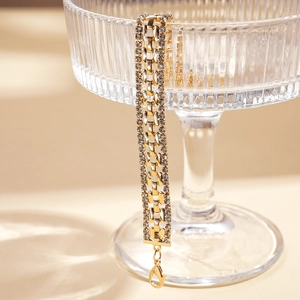 Detailed view of luxury gold link bracelet with sparkling rhinestones and lobster clasp